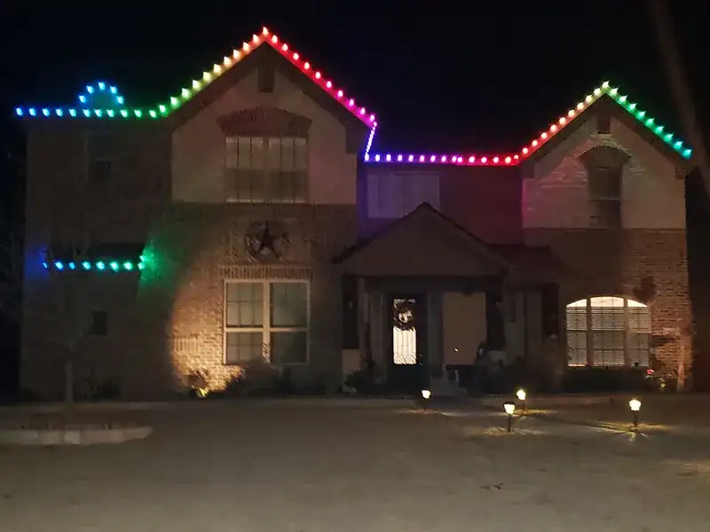 Brick home with rainbow RGB lights along the roofline