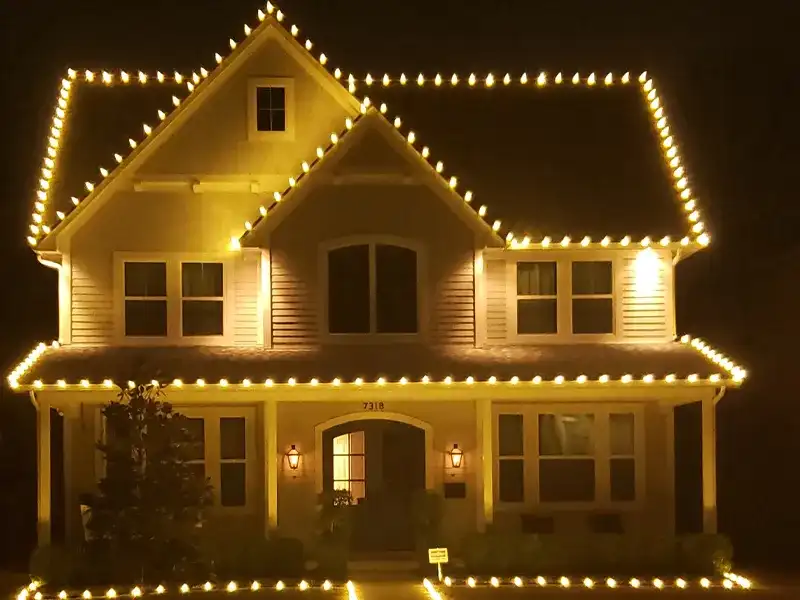 Two-story home with warm white C9 lights outlining every roofline